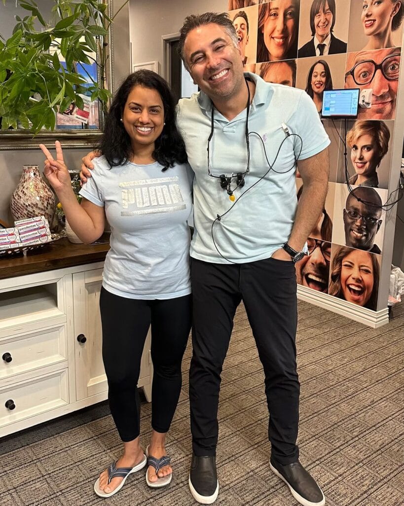 Dr Hariri of Carlsbad Shores Dentistry smiling with a happy patient after a successful dental treatment