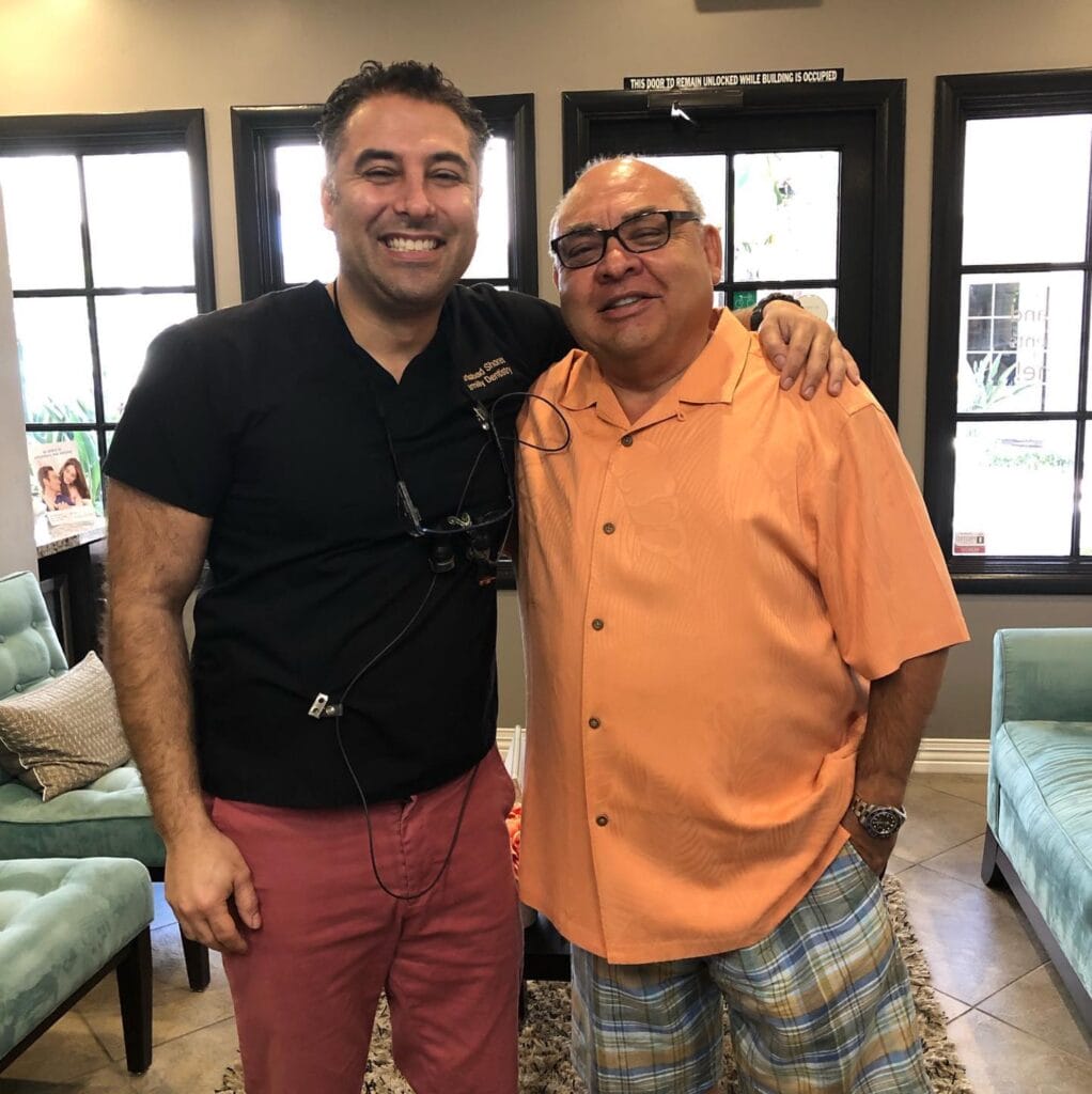 Dr Hariri of Carlsbad Shores Dentistry with a happy patient after a successful dental procedure