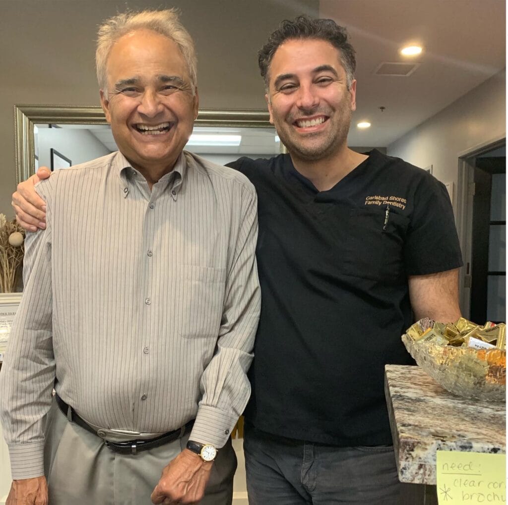 Dr Hariri of Carlsbad Shores Dentistry with a happy elderly patient after a successful dental treatment