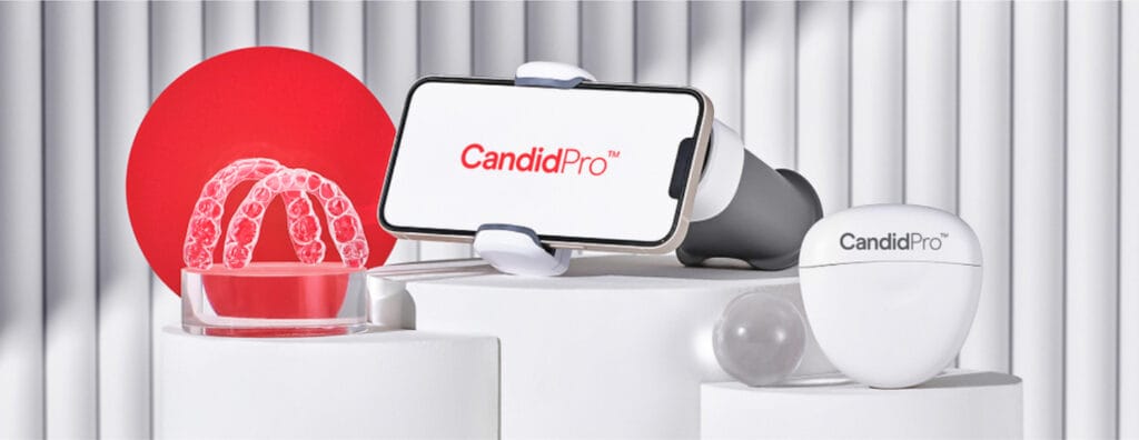 CandidPro clear aligners, Scanbox device, and smartphone app displayed on white platforms